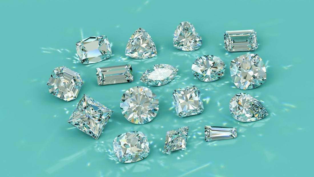 Selection of differently shaped diamonds laid out on a turquoise background