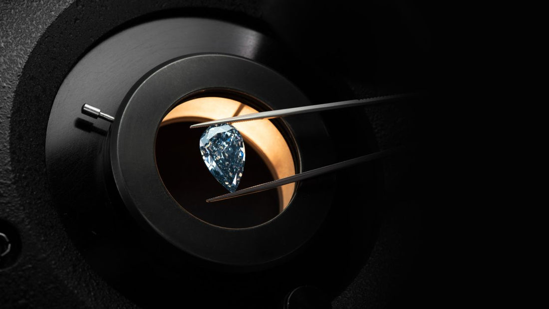 Close-up of a rare diamond mounted in a circular black jeweller viewing device against a dark background