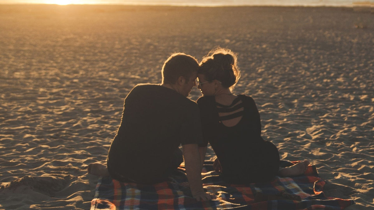 Romantic couple together at sunset, suggesting date ideas from A to Z