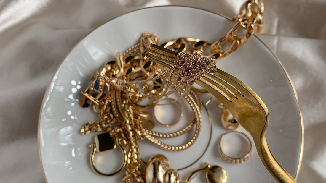 Assortment of classic gold necklaces, rings and earrings arranged as a timeless jewellery collection
