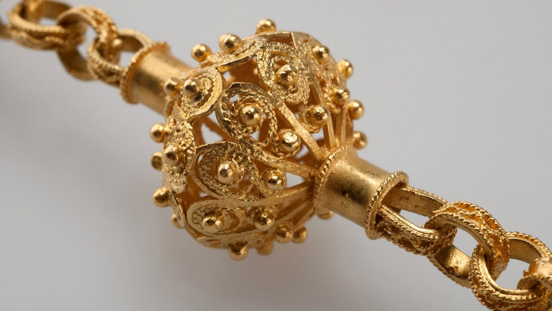 Intricate gold filigree ornament featuring delicate curling metal wires