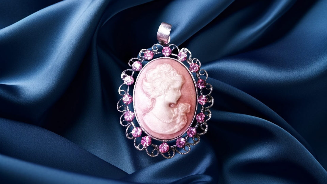 Pink carved shell cameo surrounded by diamonds and set in a gold pendant on navy satin