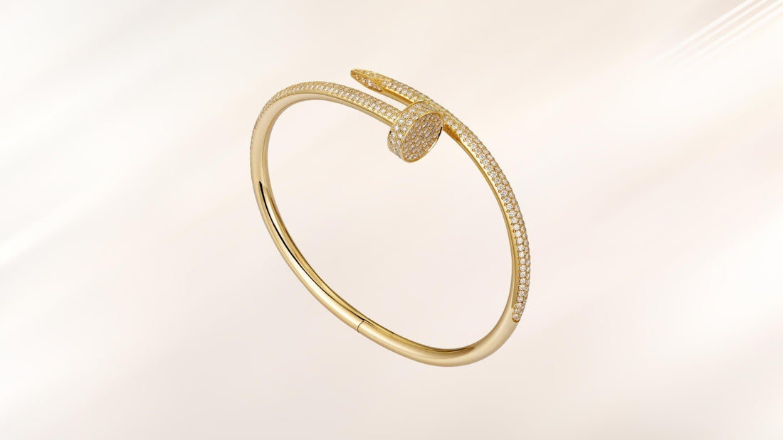Minimal gold nail-shaped Juste un Clou bracelet on a pale ivory background