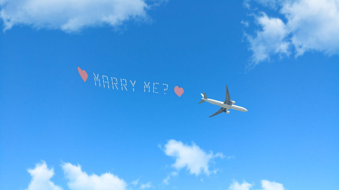 Small airplane carrying a romantic message banner through a bright blue sky