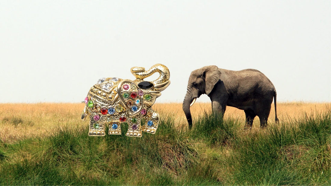 Illustration of two elephants walking through a grassy landscape, inspiring elephant jewellery motifs
