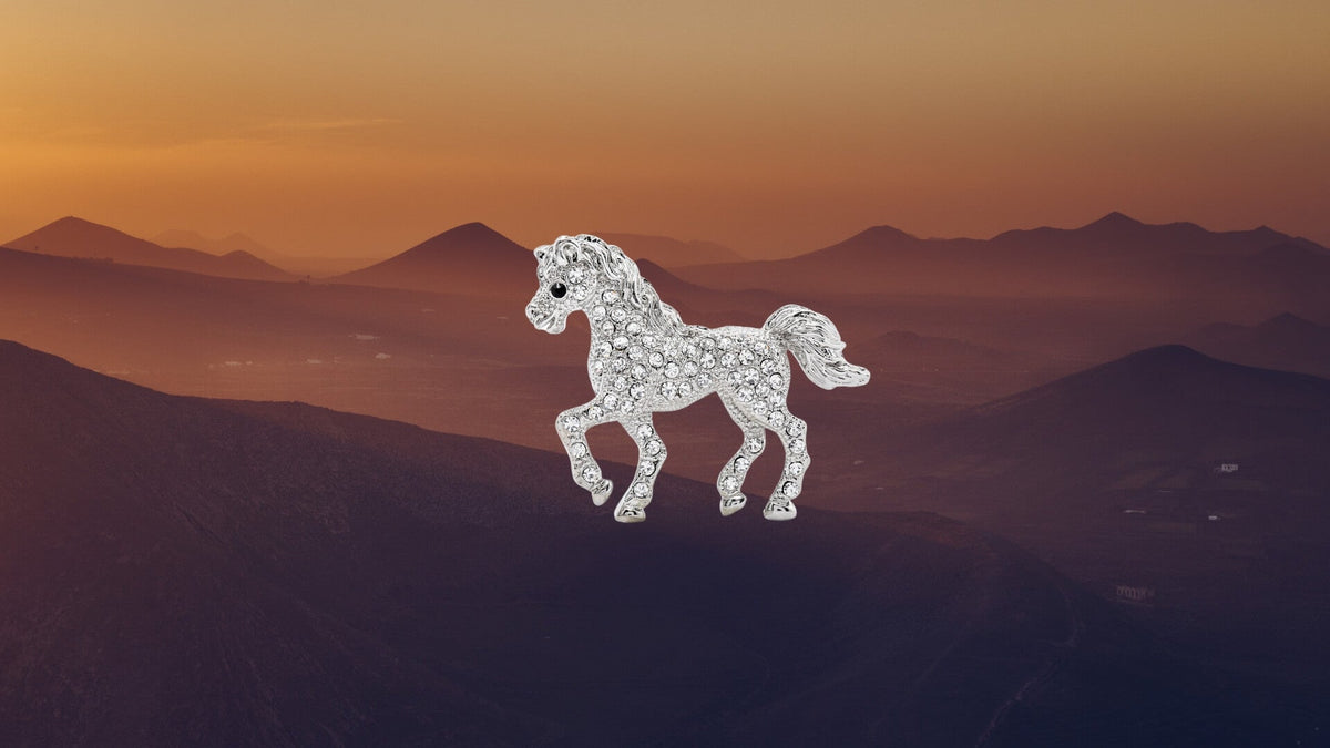White stallion running across a dusky desert landscape, illustrating horse symbolism in design