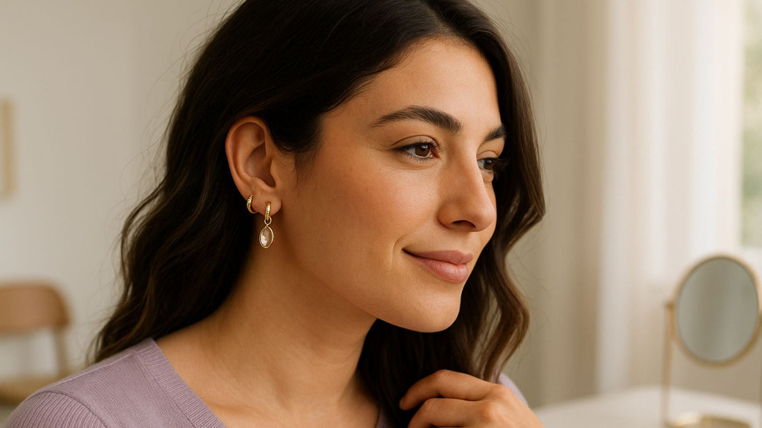 Woman wearing delicate gold earrings, showing jewellery that complements her face shape