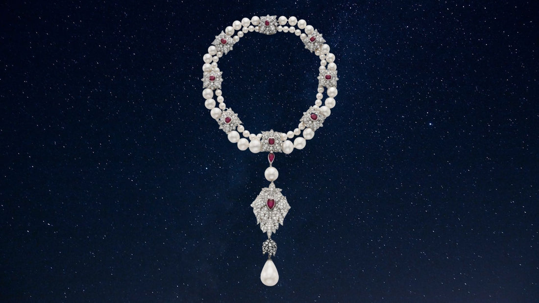Pearl drop suspended from an ornate diamond necklace against a dark background, depicting La Peregrina