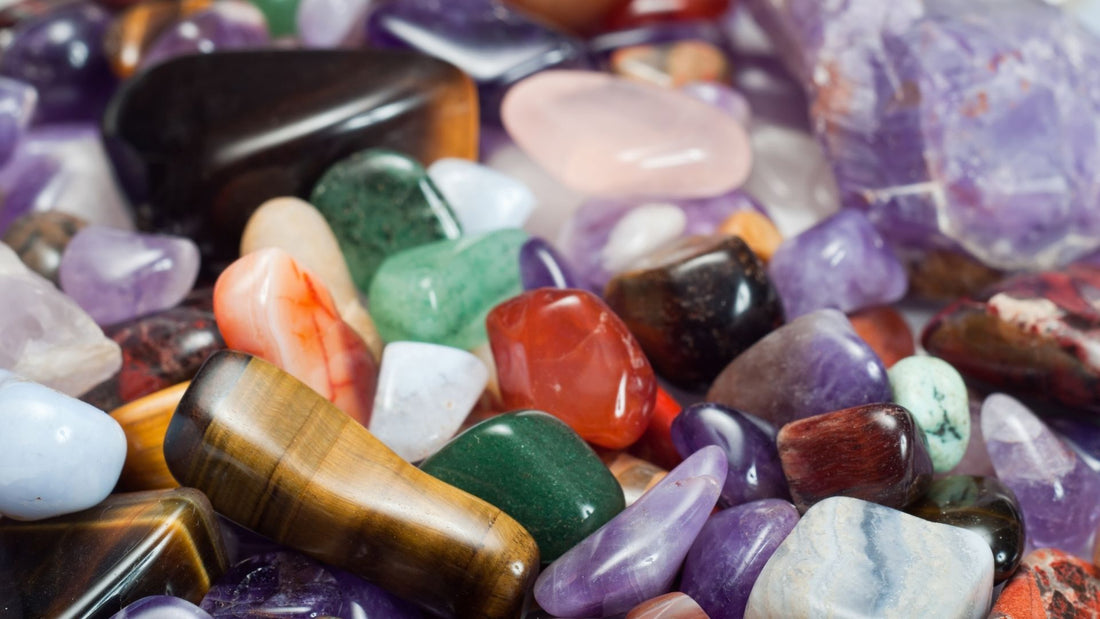 Assortment of colourful polished gemstones and mineral specimens displayed together