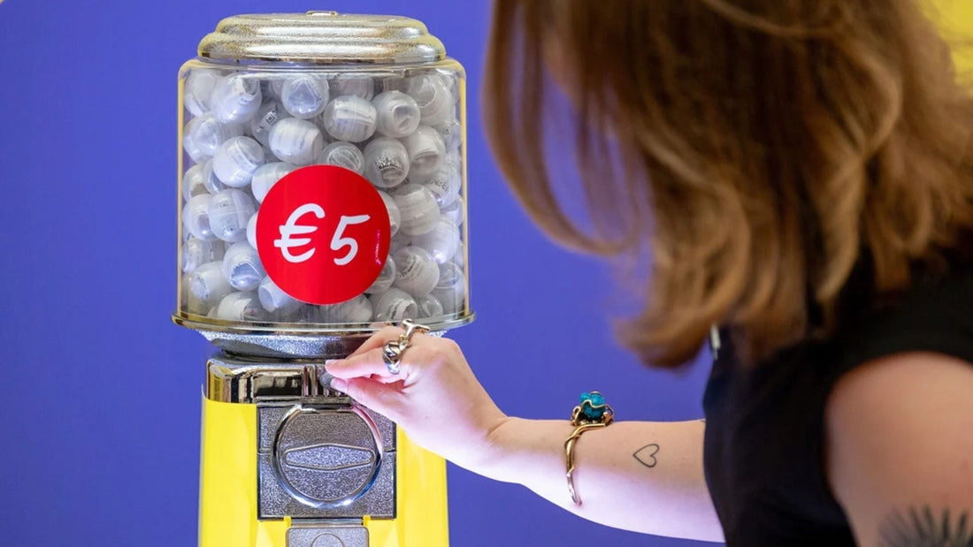 Illustration of a diamond-themed gumball vending machine with a bold red euro symbol