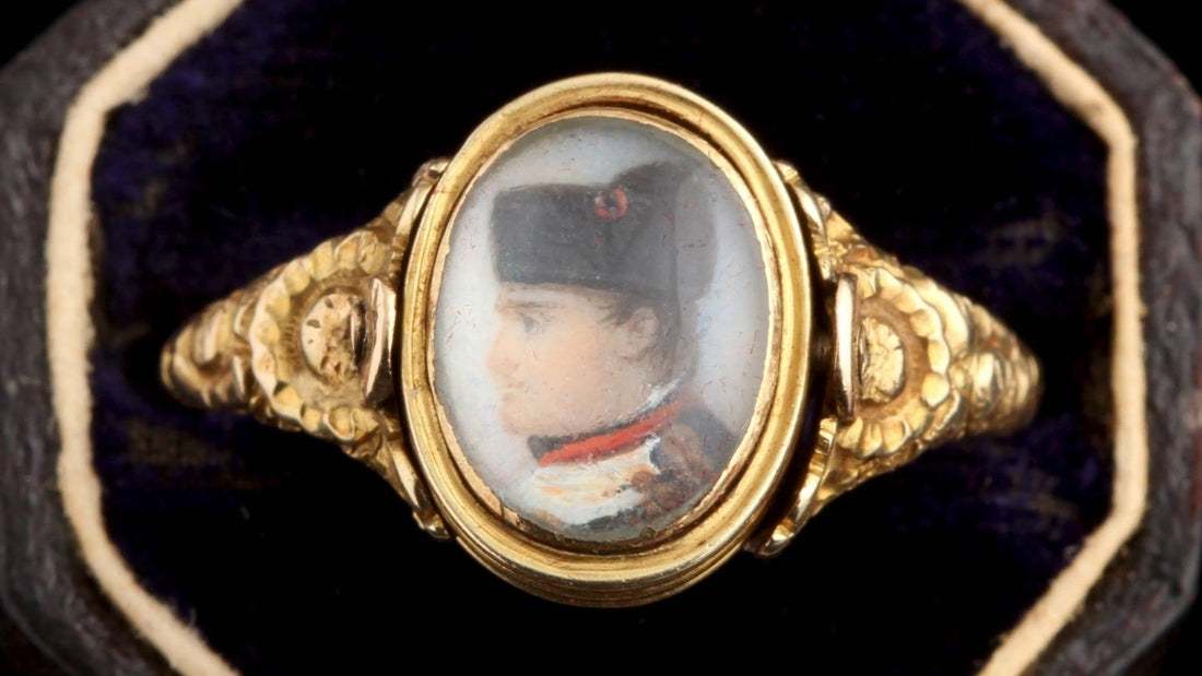 Antique gold secret-message ring featuring a miniature painted eye set beneath glass