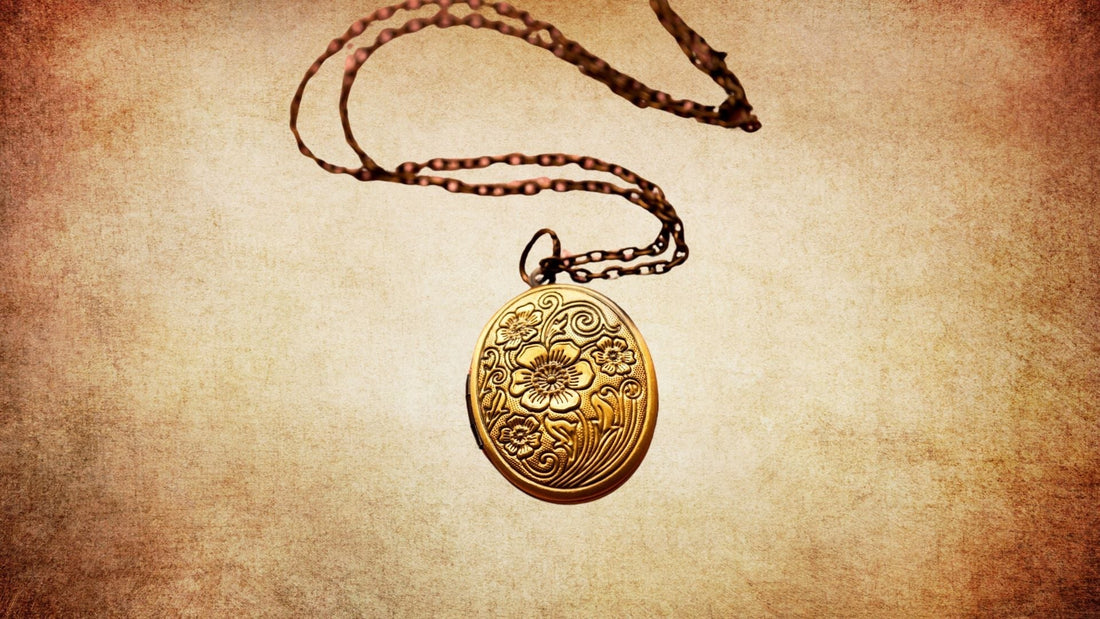 Antique portrait miniature locket pendant on a gold chain against a warm vintage background