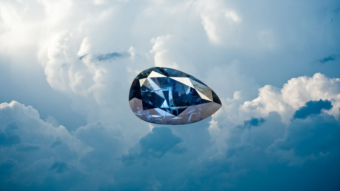 Blue sapphire gemstone floating among clouds beneath a bright sky