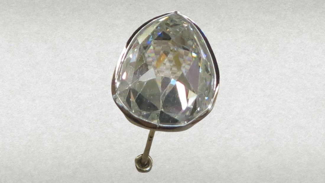 Oval colourless Sancy diamond mounted upright against a soft neutral background