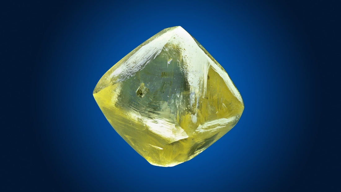 The Oppenheimer Diamond, a large yellow diamond crystal, photographed on deep blue