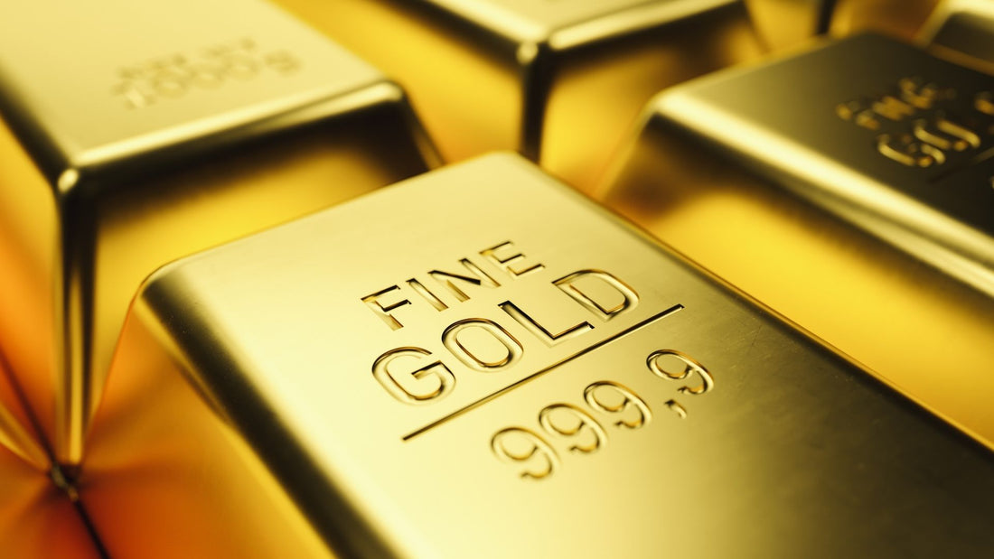 Stack of shiny gold bars stamped with their purity, illustrating gold karat measurements