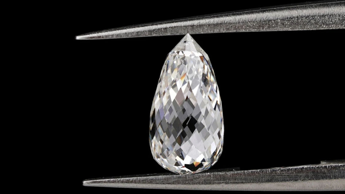 Pear-shaped briolette-cut colourless diamond displayed against a black background