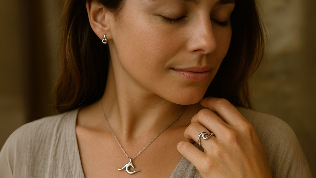 Woman holding a wave-shaped pendant necklace close to her chest, evoking flow and resilience