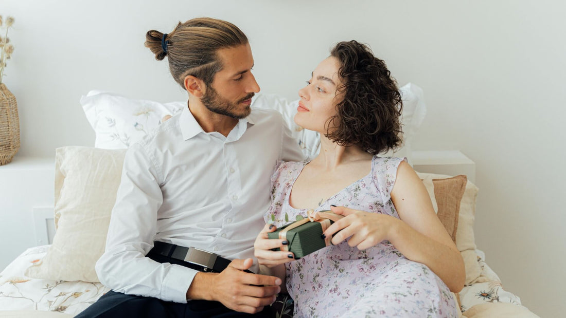Smiling couple celebrating together outdoors, suggesting traditional anniversary gifts