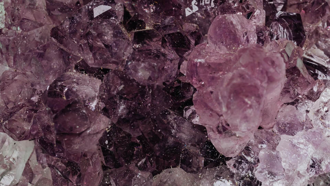 Protective crystals and purple mineral clusters arranged close together on a textured surface