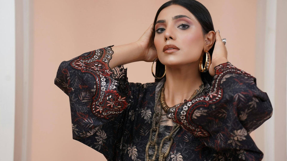 Woman modelling oversized sculptural hoop earrings against a neutral background