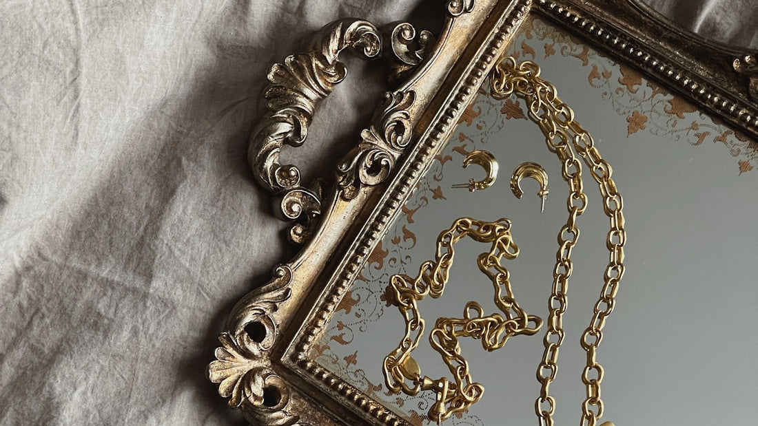 Jewellery-maker arranging layered necklaces and personal accessories to create a signature look
