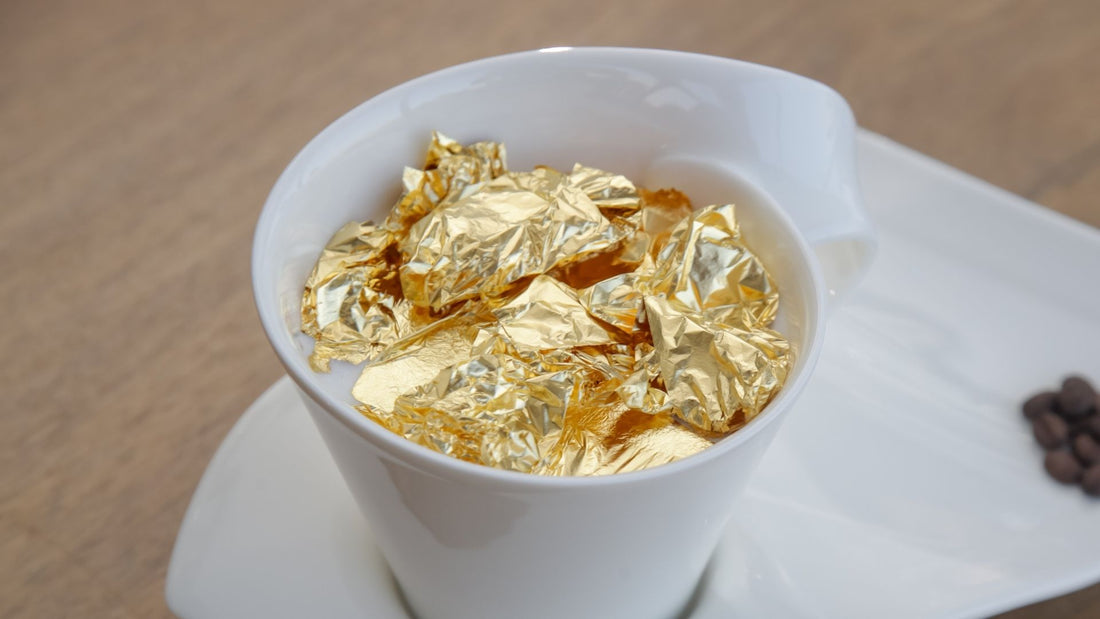 Small flakes of edible gold leaf served over a plated dessert