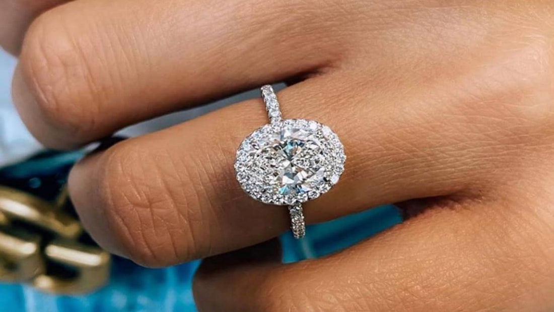 Close-up of a diamond engagement ring on a finger, illustrating total carat weight