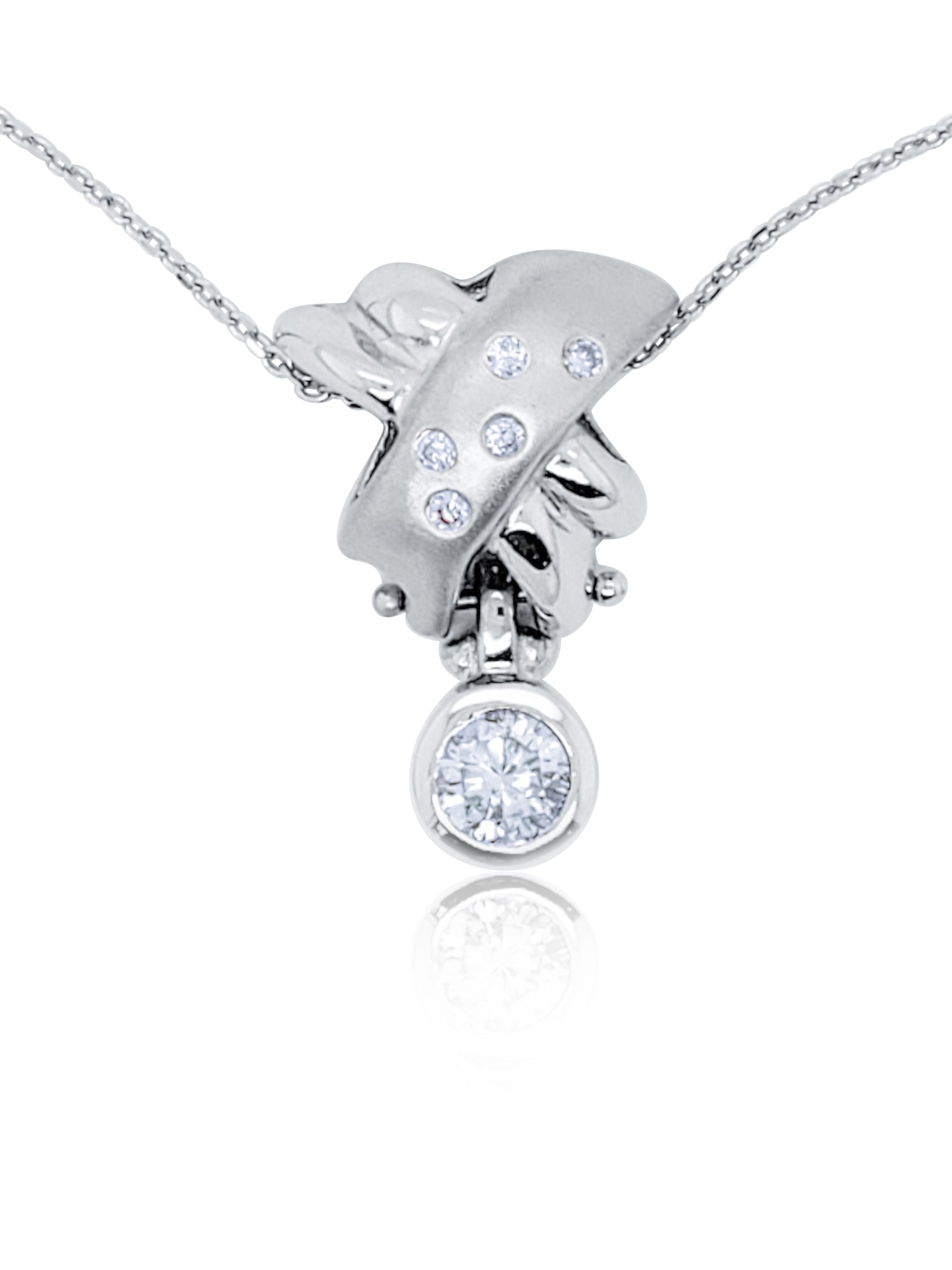18kt white gold diamond pendant featuring 0.60 ct round center and 0.10 cts around