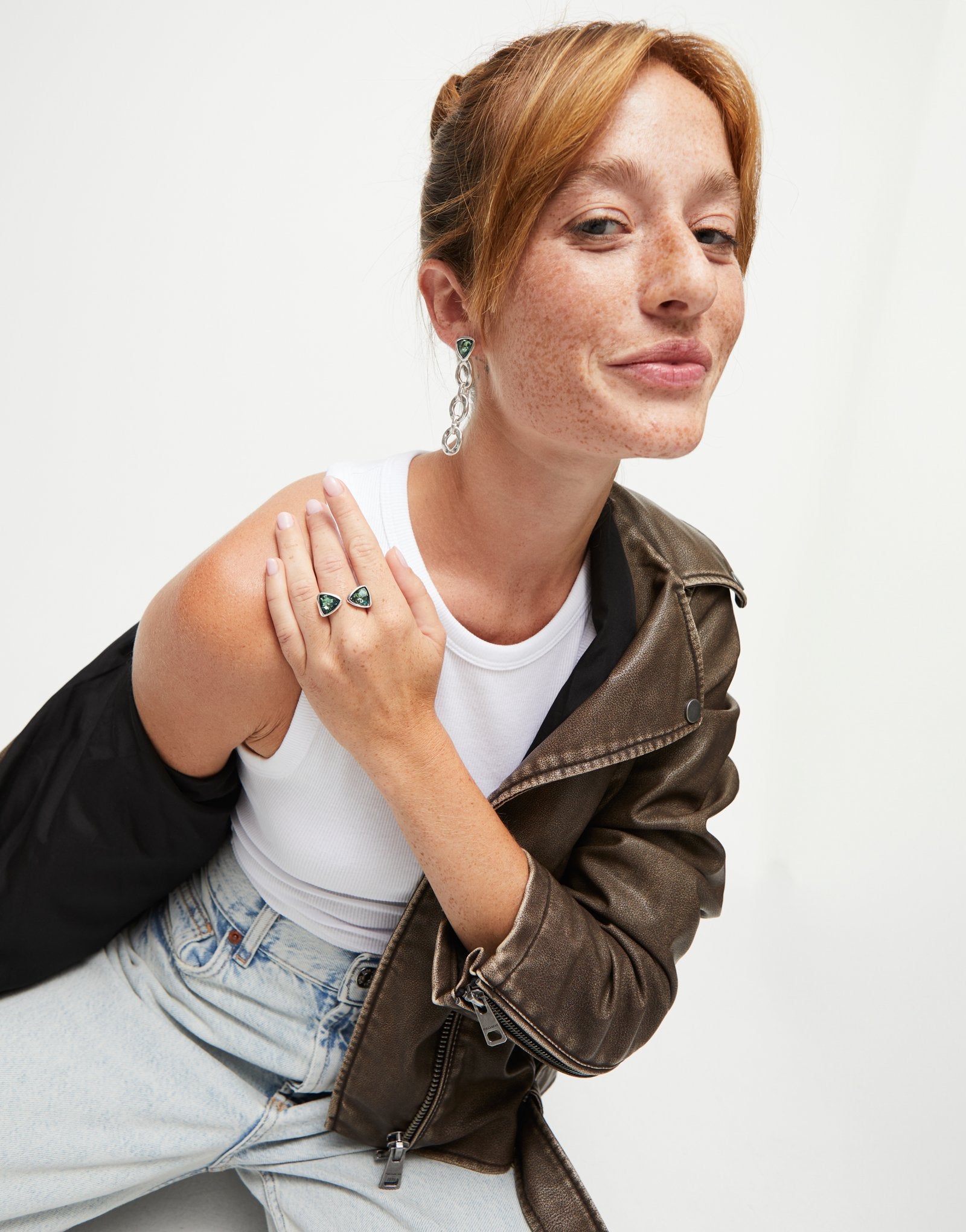 Triangular ring with two green crystals