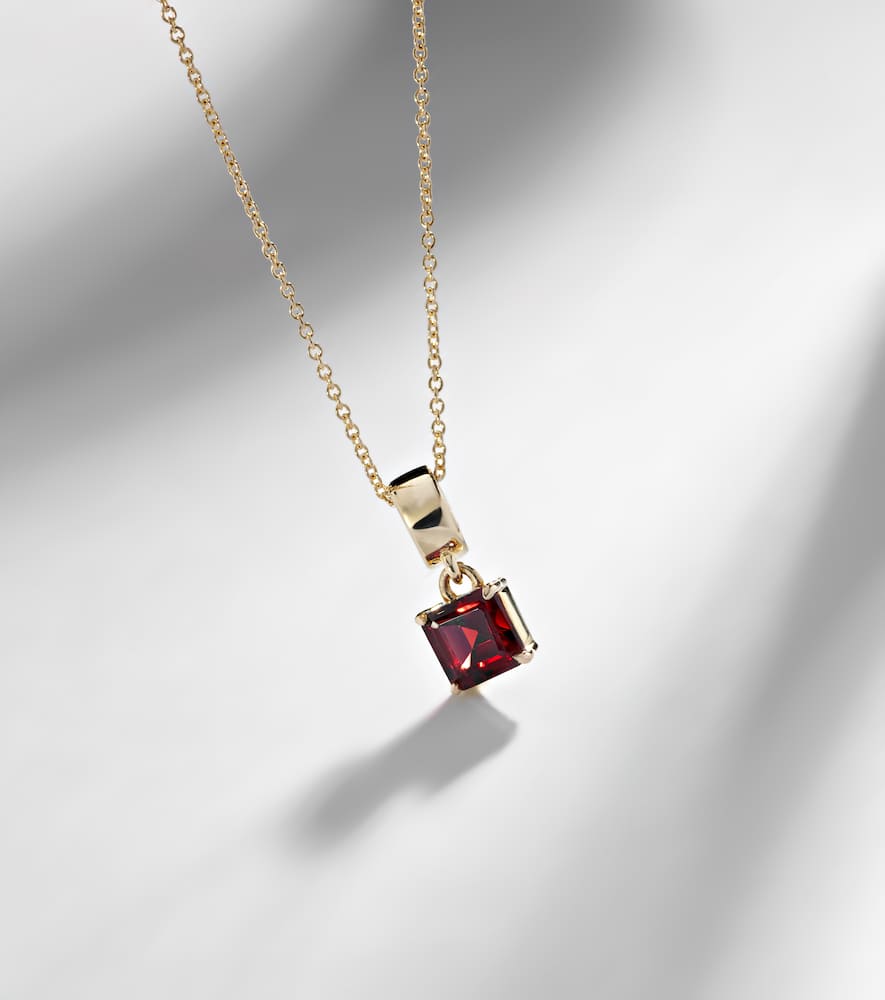 10kt gold charm necklace with garnet