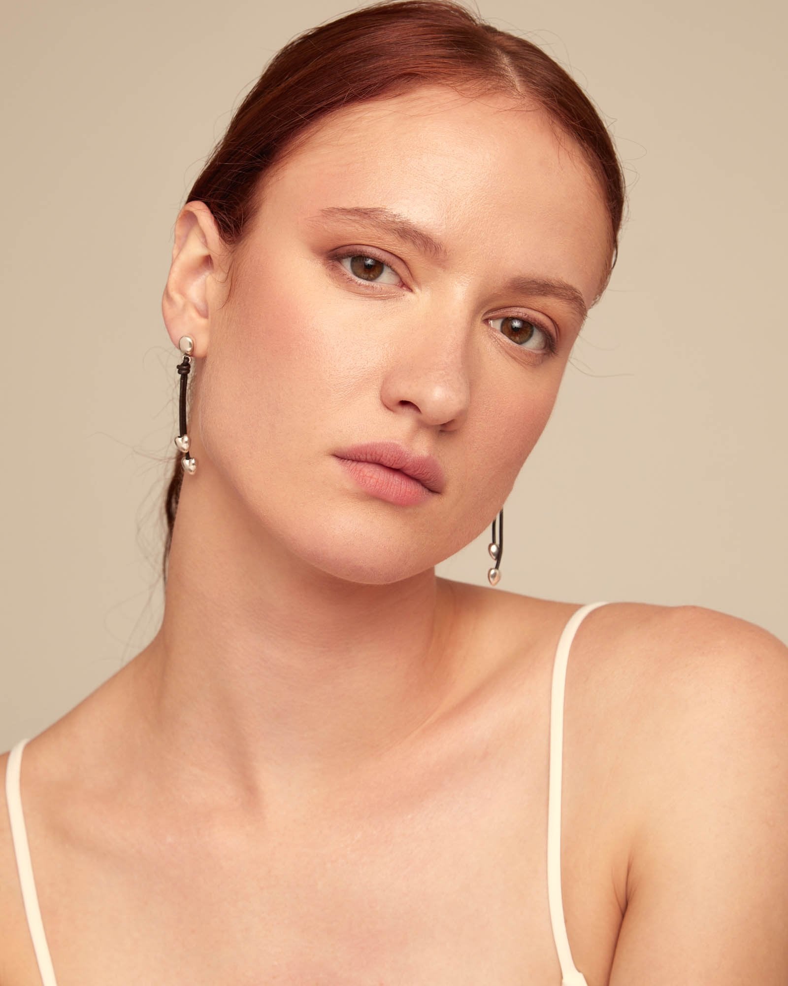 Leather drop earrings with two small hearts