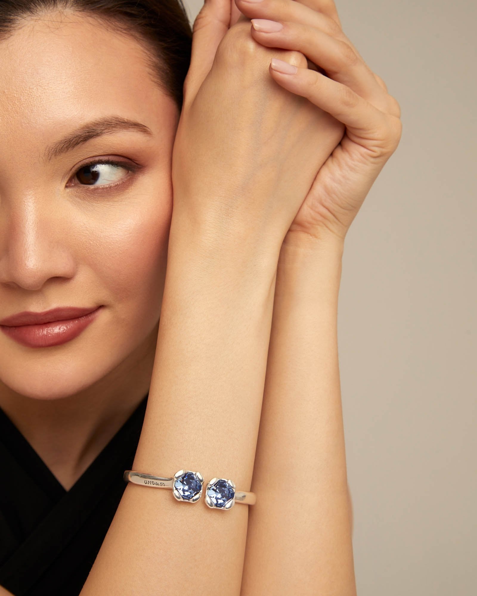 Bangle bracelet with two blue crystals