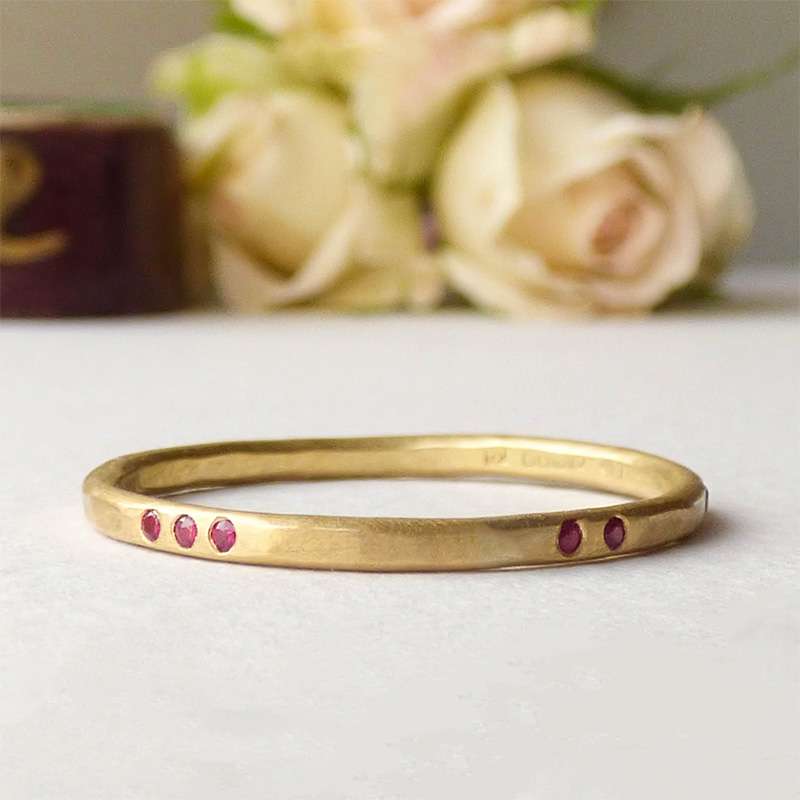 Ruby-Evie — Hammered 18ct Fairmined Gold Wedding Band with Rubies