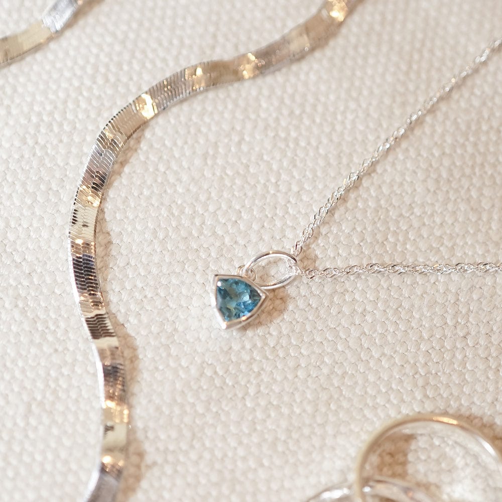 blue-topaz-december-birthstone-charm-necklace-sterling-silver-daisy-london