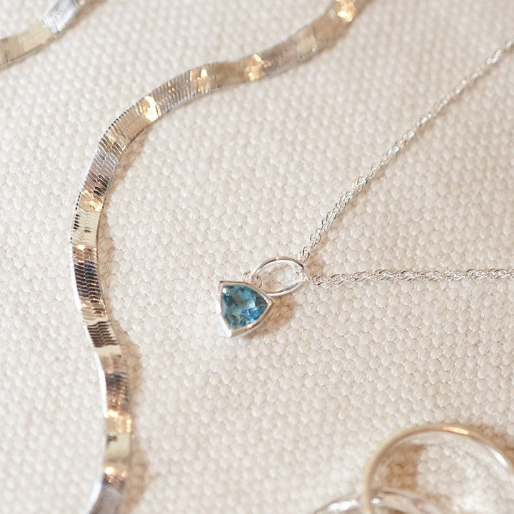 blue-topaz-december-birthstone-charm-necklace-sterling-silver-daisy-london