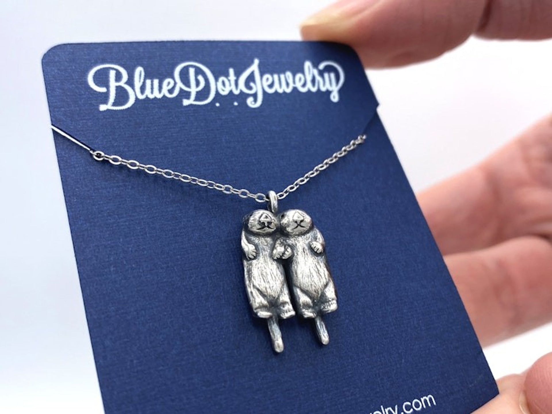 Two Silver Otters Holding Hands Necklace