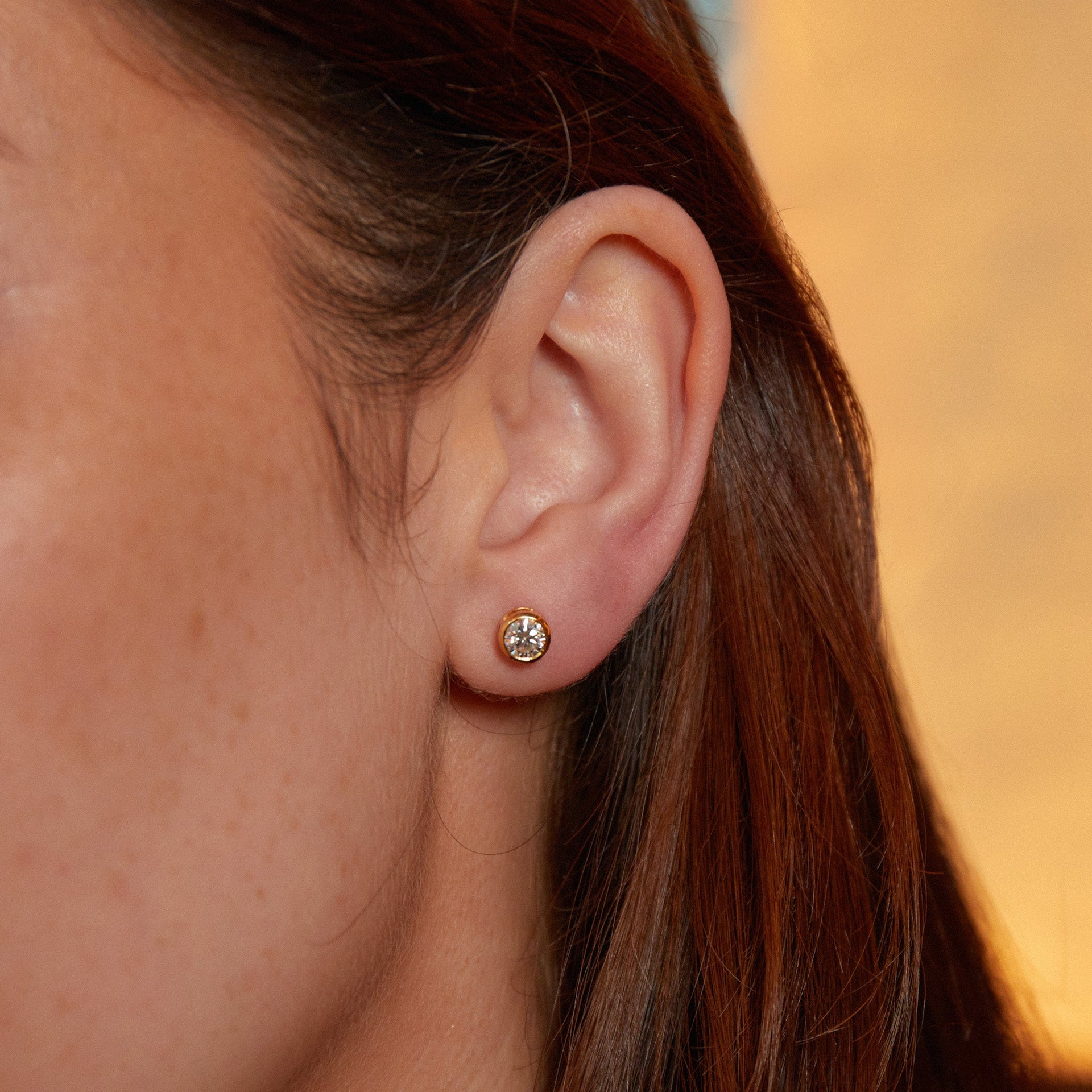 Delicate Round Shaped Gold Diamond Stud Earrings Bezel Set