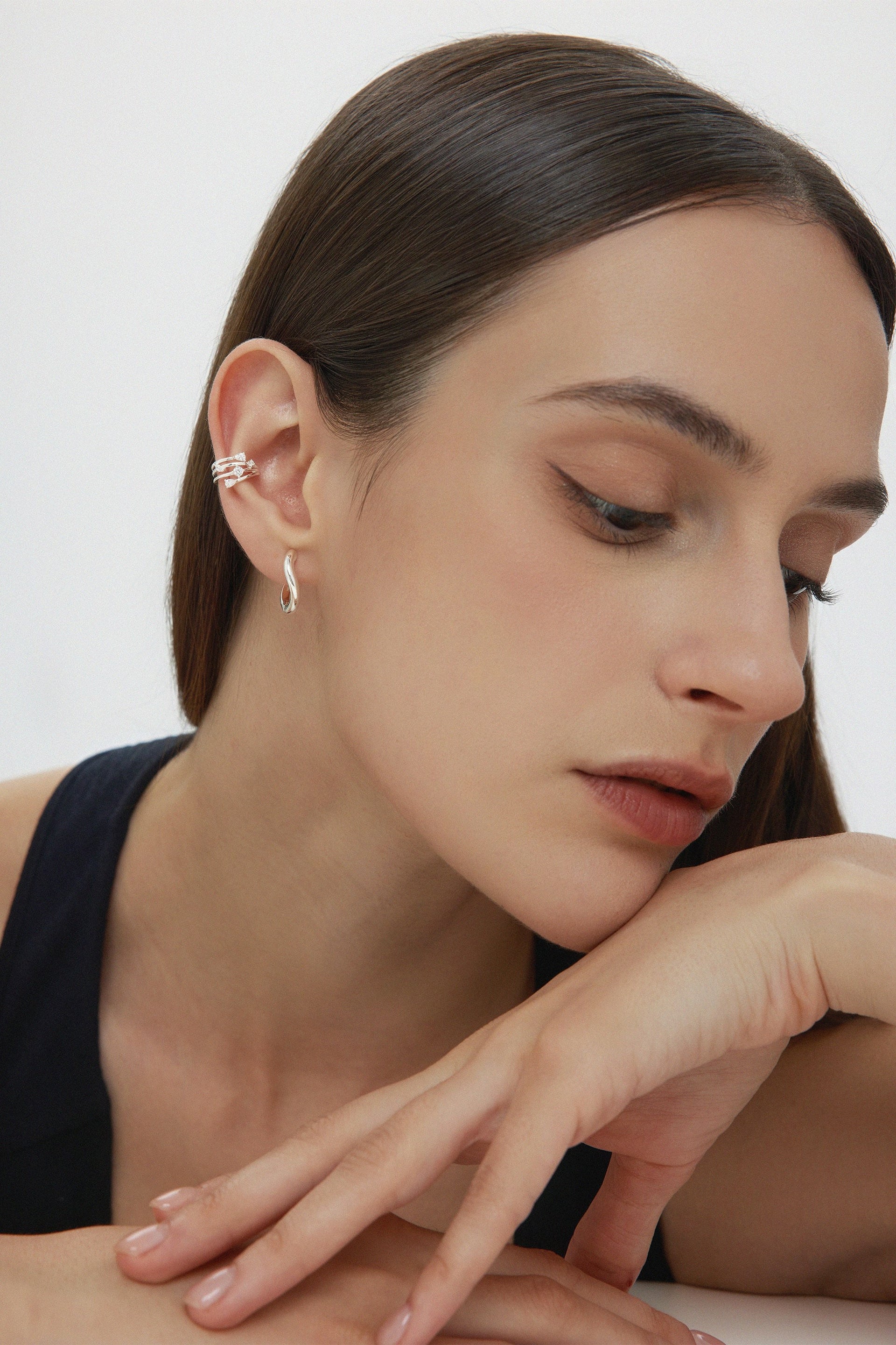 Nori Twisted Hoop Earrings In Silver